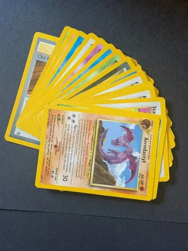 A fanned-out stack of around twenty yellow-bordered cards, an Aerodactyl on top.