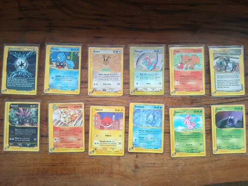 Twelve e-Reader era cards laid out in two rows on a wooden table.